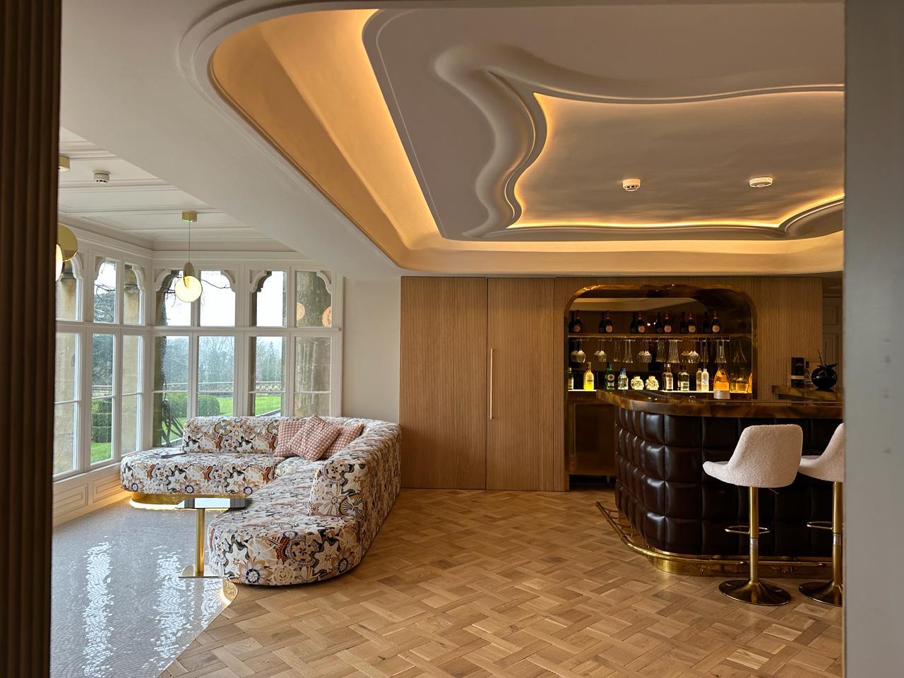 The Estate — bar room with sculpted illuminated ceiling