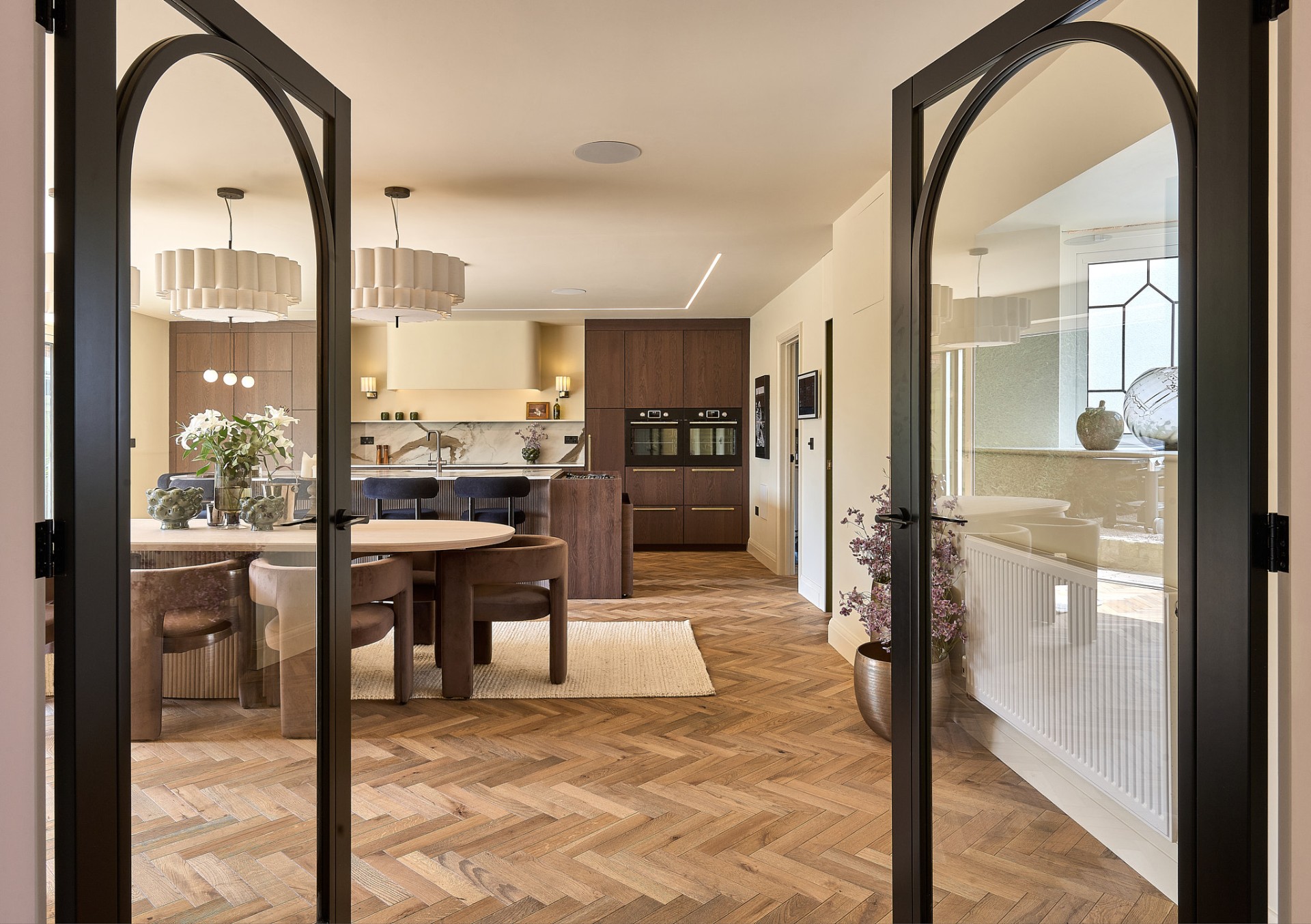 The Muse — arched steel doors framing the kitchen