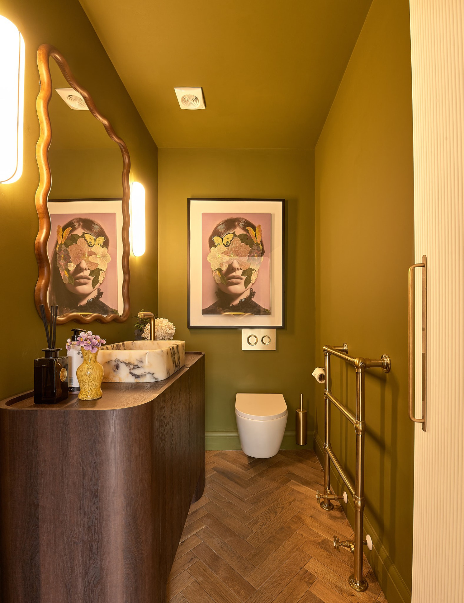 The Muse — powder room in deep olive with marble and brass