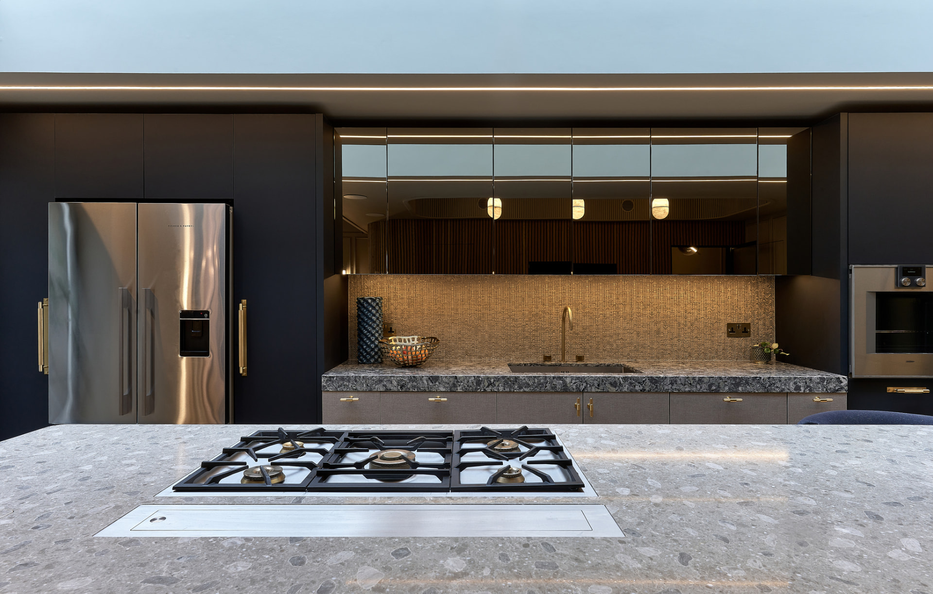 The Townhouse — ink kitchen with woven brass mosaic and gas hob on the terrazzo island