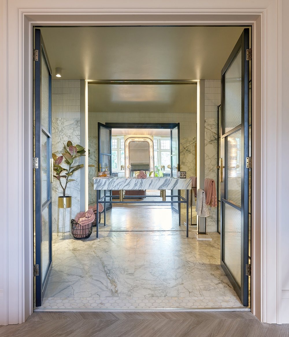 The House on the Park — en suite entry with Crittall doors and marble vanity beyond